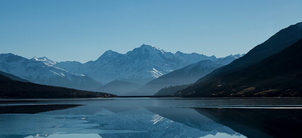 Peaceful mountain landscape with clear reflections in a calm lake.